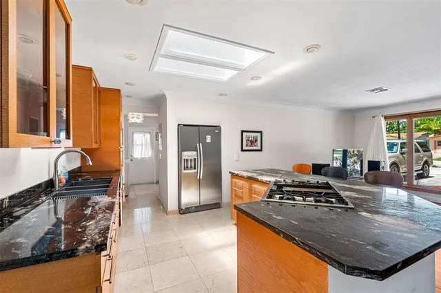 a kitchen with granite countertop a stove and a sink