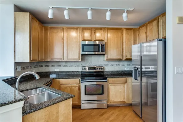 a kitchen with a sink cabinets and stainless steel appliances