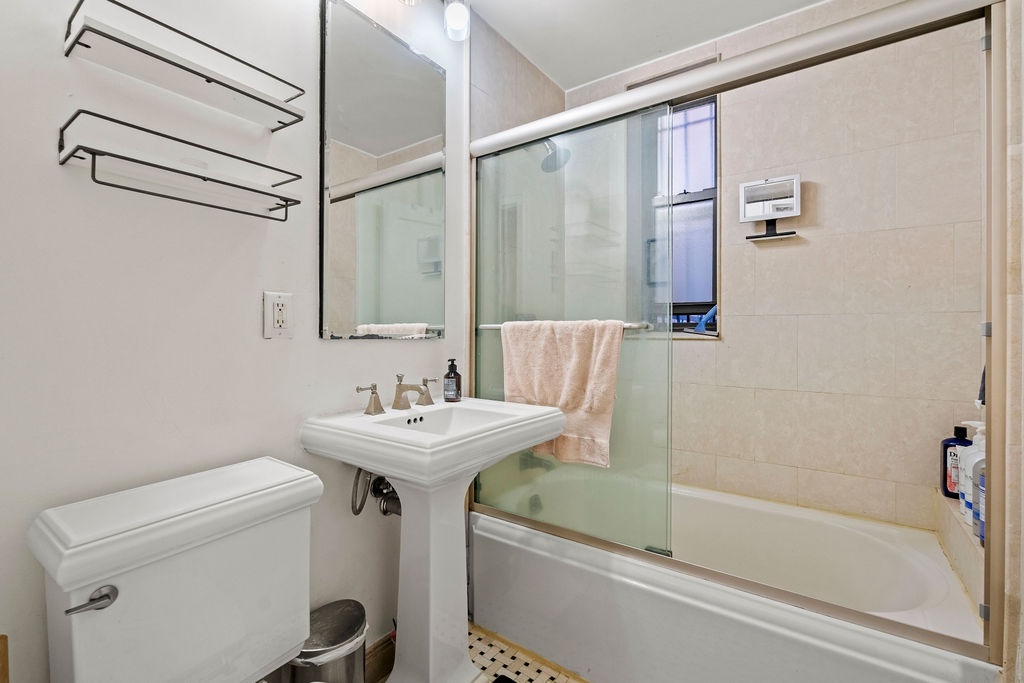 225 East 74th Street, Unit 3F Manhattan, NY 10021 - Photo 10 of 11 a bathroom with a sink a toilet and a bathtub