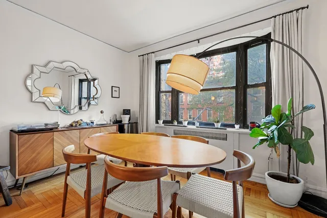a dining room with furniture and window