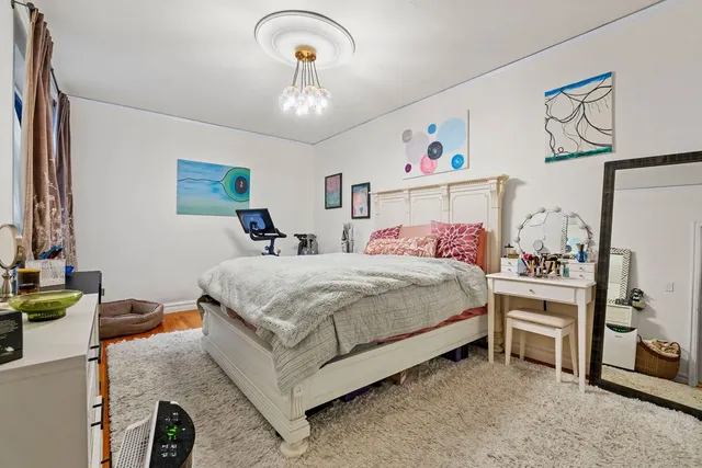 a bedroom with a bed and a chandelier