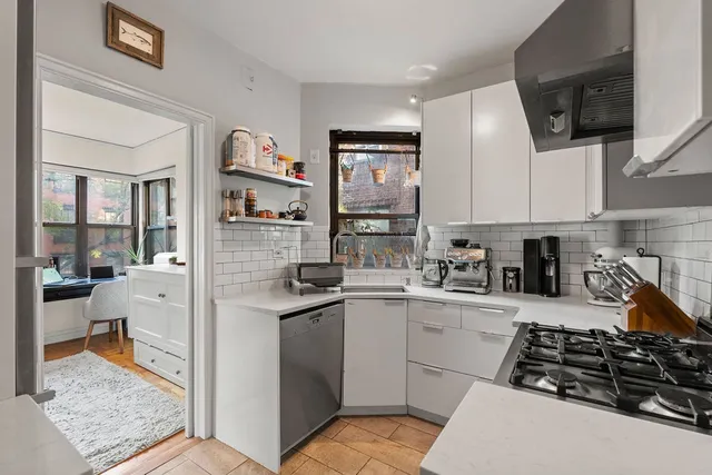 a kitchen with stainless steel appliances a stove a sink and a refrigerator