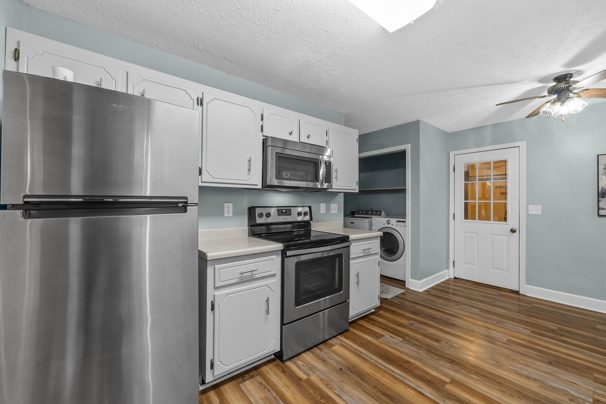 105 Good Hope Cemetery Road Oak Grove, KY 42262 - Photo 13 of 33 a kitchen with a refrigerator stove and wooden cabinets