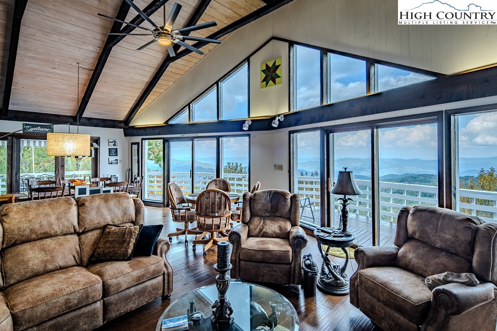 206 Pinnacle Ridge Road Beech Mountain, NC 28604 - Photo 6 of 41 a living room with furniture a ceiling fan and a large window