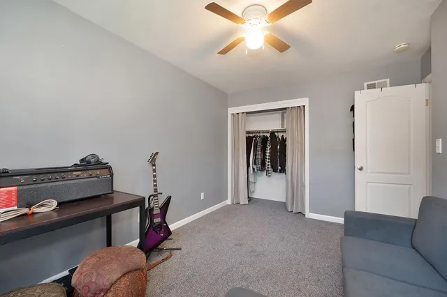a view of a livingroom with furniture and a ceiling fan