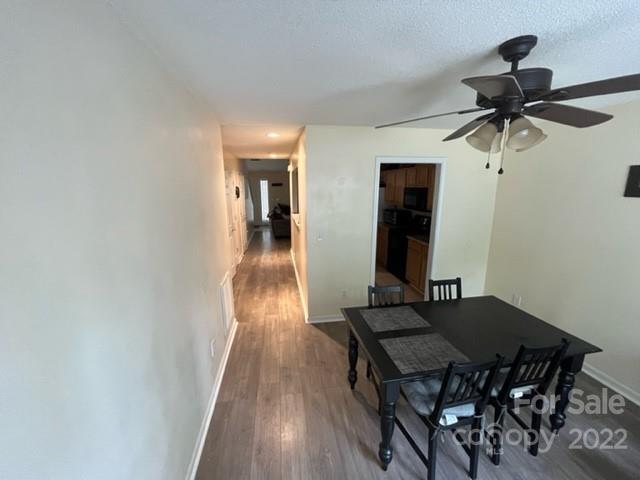 11047 Pointer Ridge Drive Charlotte, NC 28214 - Photo 12 of 26 a view of a dining room with furniture and a wooden floor