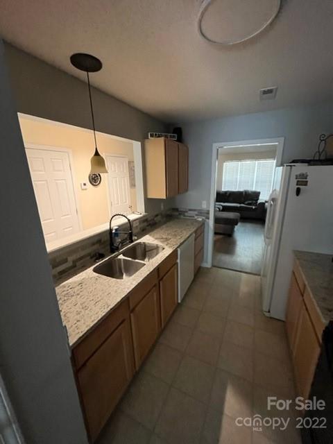 11047 Pointer Ridge Drive Charlotte, NC 28214 - Photo 7 of 26 a kitchen with stainless steel appliances granite countertop a sink a stove and a refrigerator