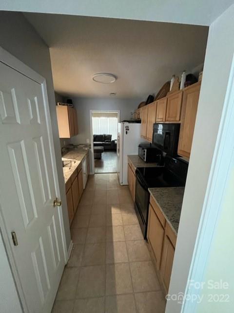11047 Pointer Ridge Drive Charlotte, NC 28214 - Photo 9 of 26 a kitchen with granite countertop a refrigerator stove and sink