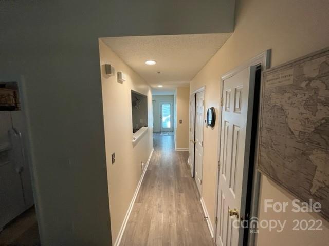 11047 Pointer Ridge Drive Charlotte, NC 28214 - Photo 10 of 26 a view of a hallway with wooden floor and a bathroom