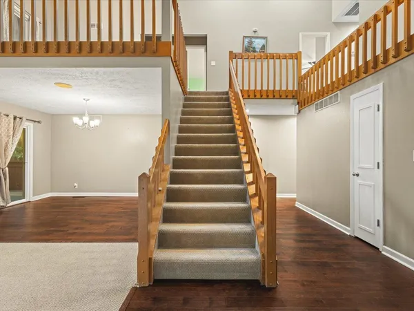 a view of entryway and hall with wooden floor