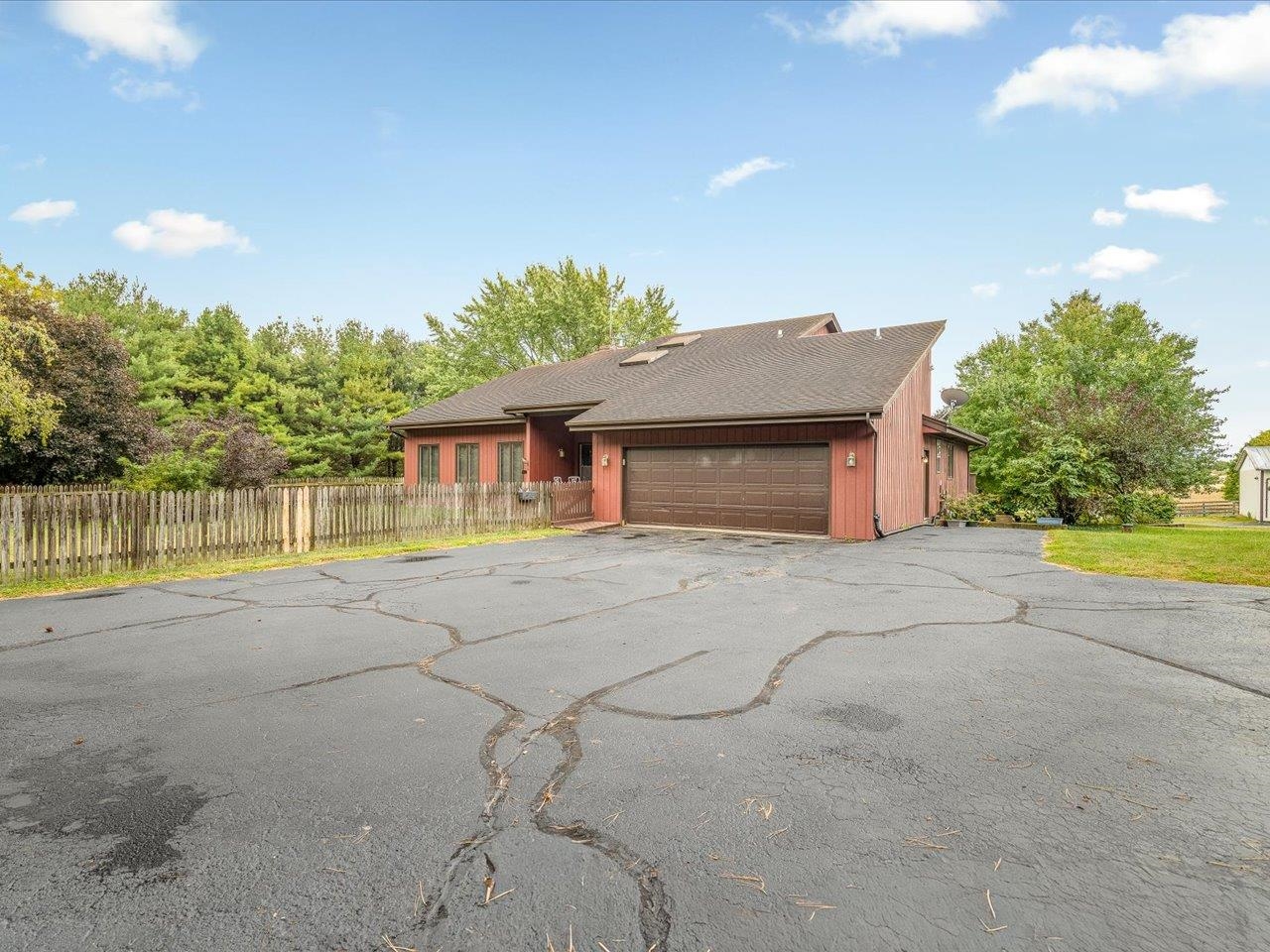 9104 East Weber Road Ridott, IL 61067 - Photo 13 of 96 a front view of a house with a yard and a garage