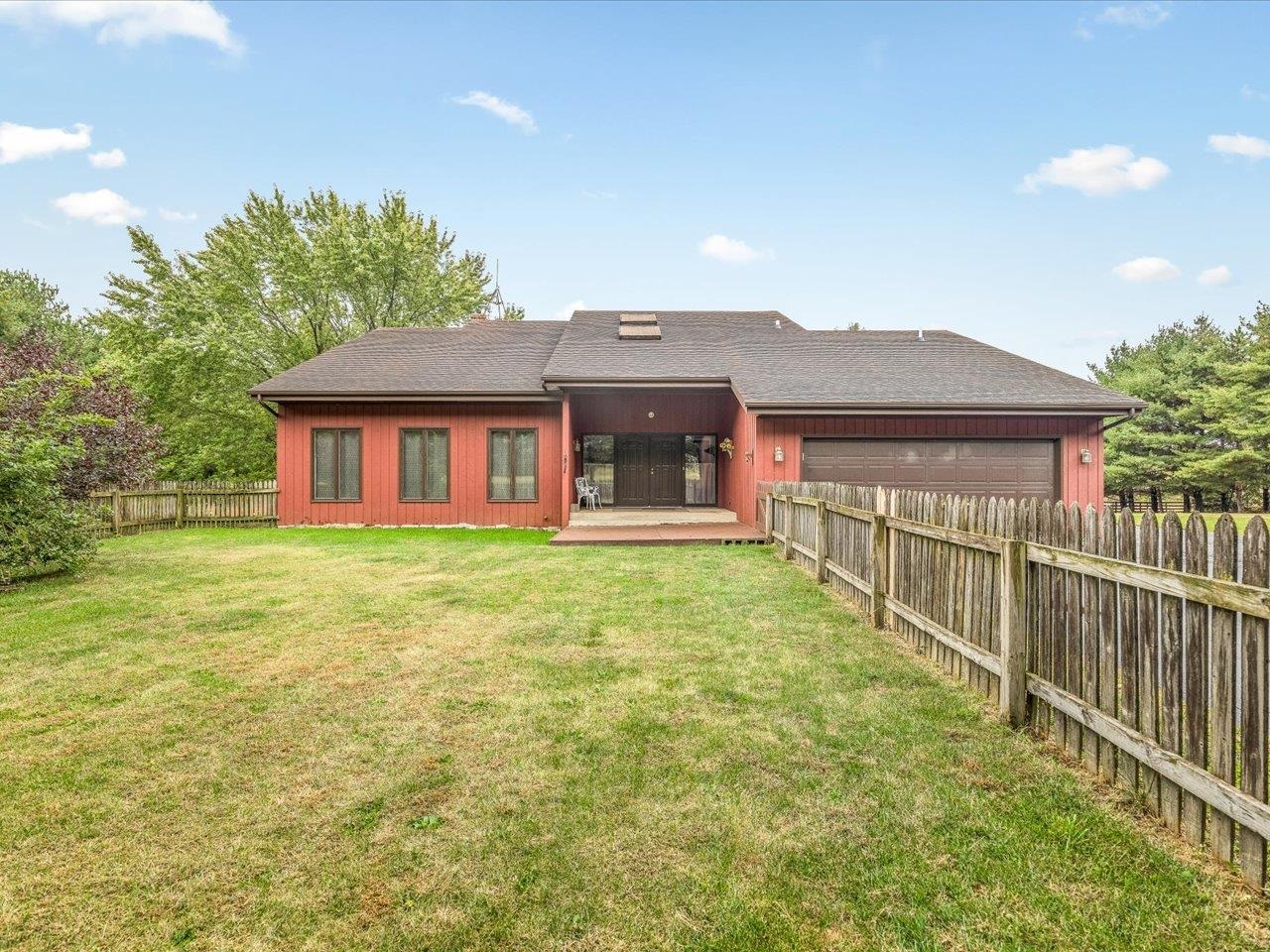 9104 East Weber Road Ridott, IL 61067 - Photo 14 of 96 a front view of a house with a garden