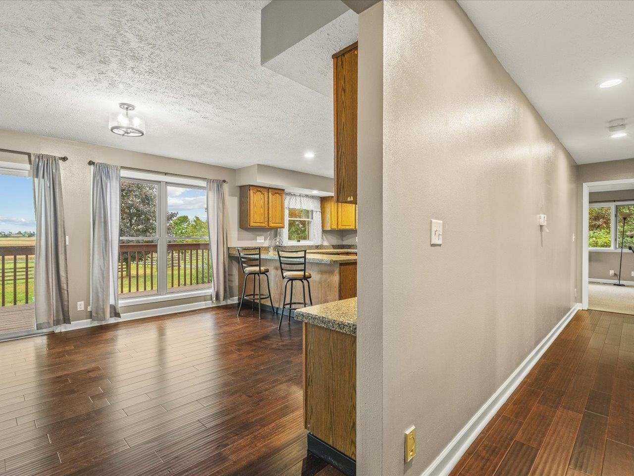 9104 East Weber Road Ridott, IL 61067 - Photo 18 of 96 a view of a big room with wooden floor and windows