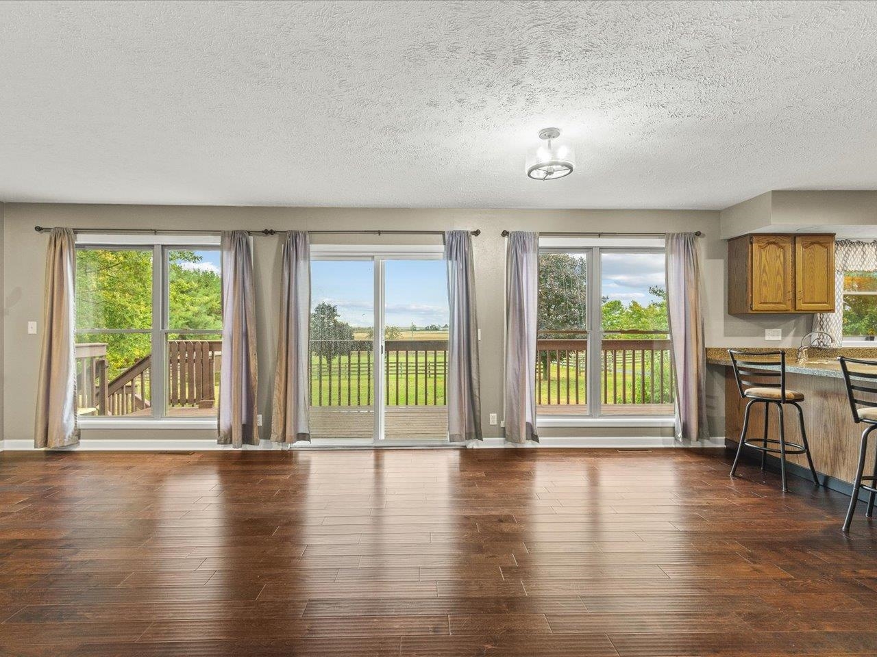 9104 East Weber Road Ridott, IL 61067 - Photo 19 of 96 a view of an empty room with a window and wooden floor