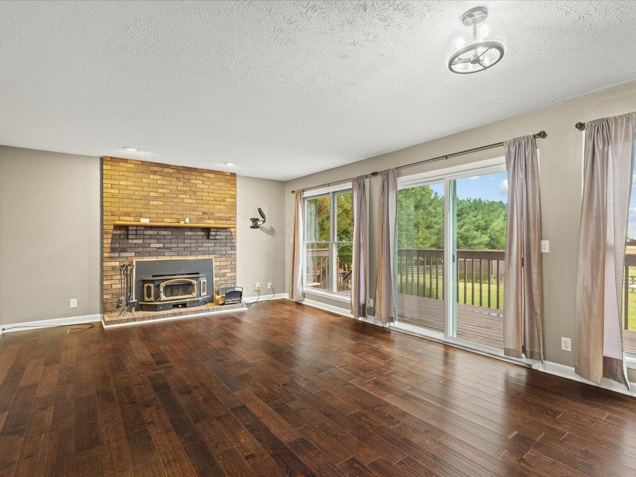9104 East Weber Road Ridott, IL 61067 - Photo 20 of 96 a view of an empty room with a fireplace and a window