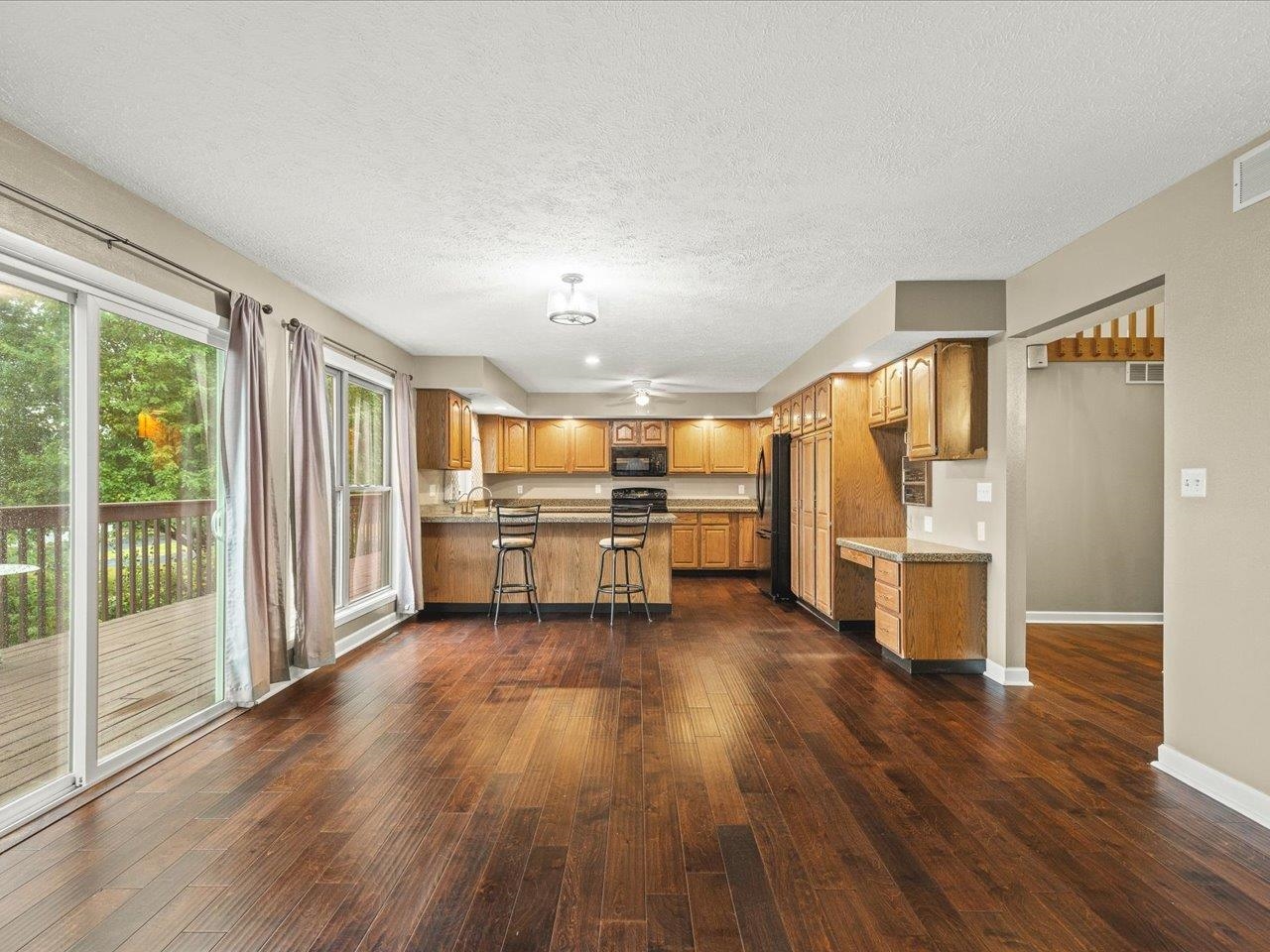 9104 East Weber Road Ridott, IL 61067 - Photo 22 of 96 a view of a kitchen with wooden floor electronic appliances and windows