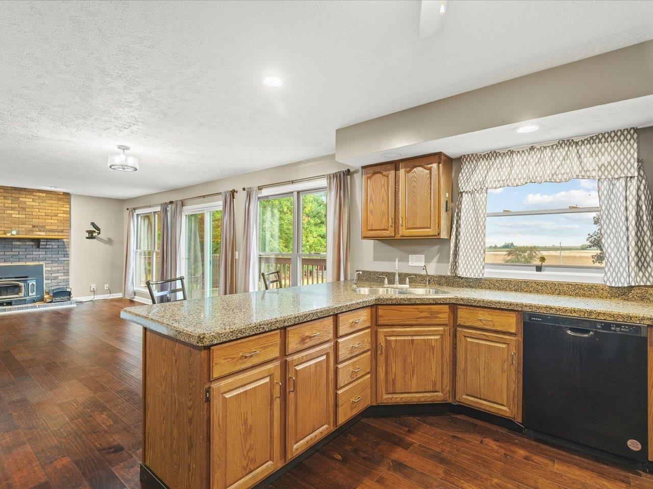 9104 East Weber Road Ridott, IL 61067 - Photo 25 of 96 a kitchen with a sink stove and cabinets