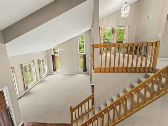 a living room with a large window and a fireplace