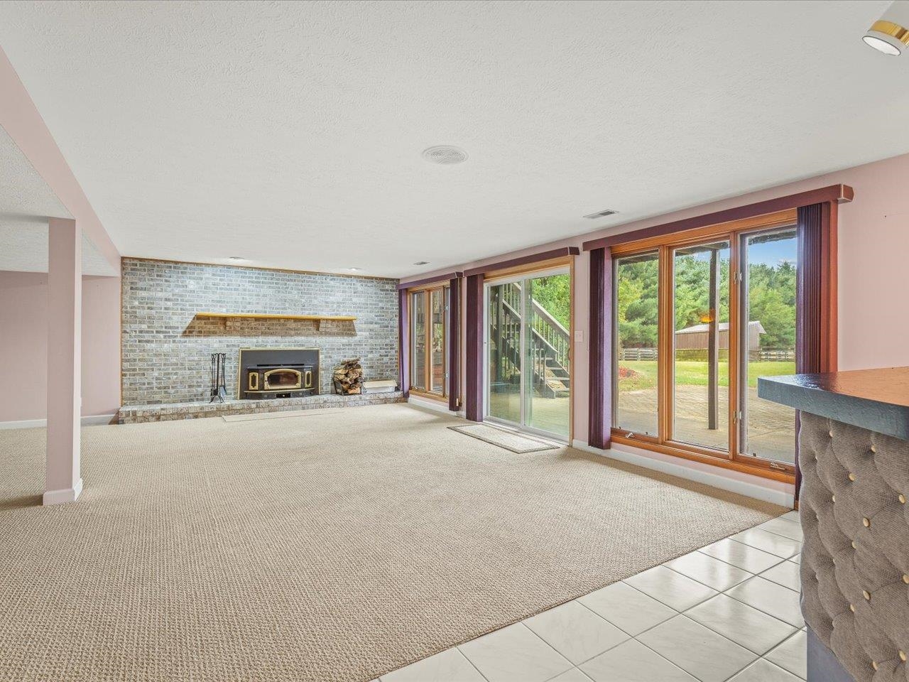 9104 East Weber Road Ridott, IL 61067 - Photo 46 of 96 a living room with a large window and a fireplace