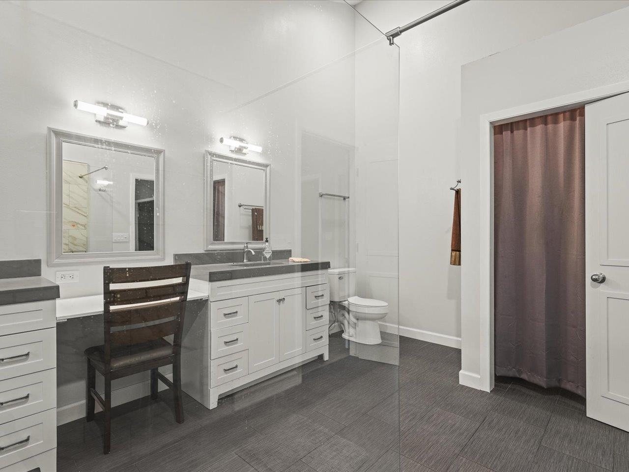 9104 East Weber Road Ridott, IL 61067 - Photo 78 of 96 a spacious bathroom with a double vanity sink a mirror and a toilet