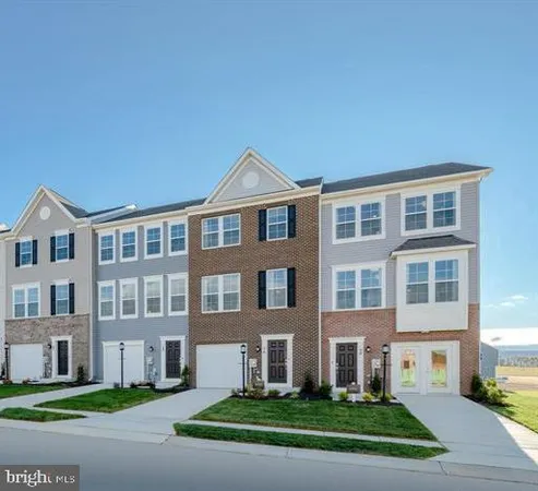 a front view of a residential apartment building with a yard