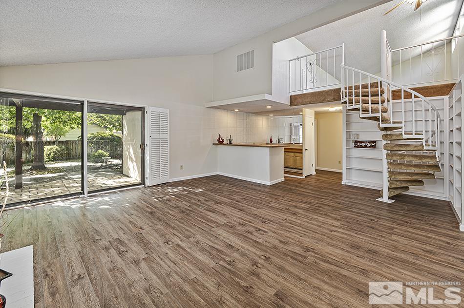 1600 Foster Drive Reno, NV 89509 - Photo 4 of 22 a view of empty room with wooden floor and windows