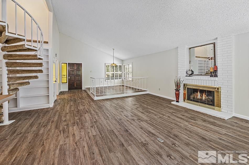 1600 Foster Drive Reno, NV 89509 - Photo 6 of 22 a view of empty room with wooden floor and fireplace