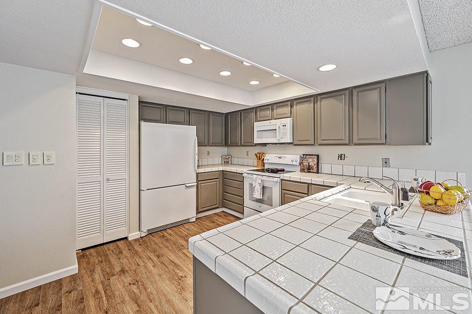 1600 Foster Drive Reno, NV 89509 - Photo 9 of 22 a kitchen with a sink appliances and cabinets