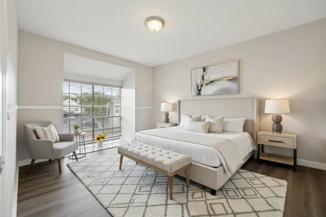 a bedroom with a balcony a bed and a couch