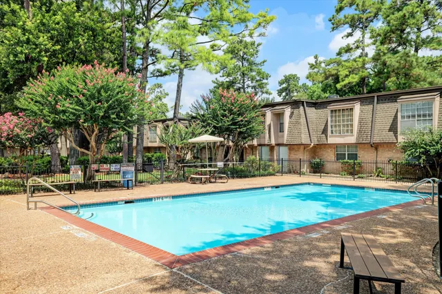 a view of a backyard with swimming pool