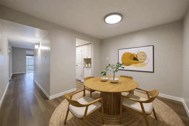 a view of a dining room with furniture and wooden floor