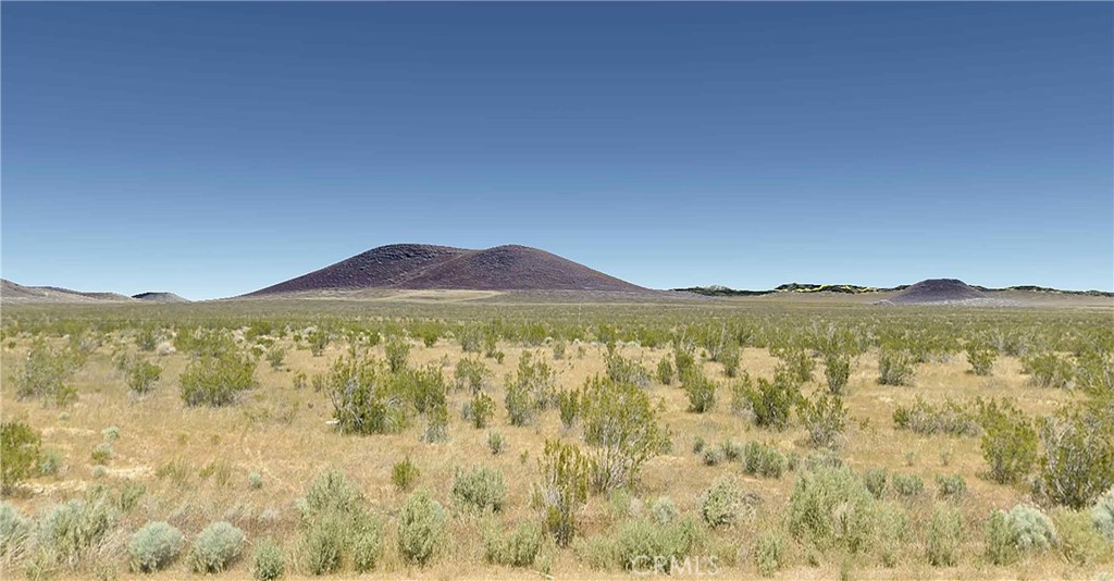64 Sunset Avenue Mojave, CA 93501 - Photo 5 of 7 a view of a mountain range in a cloudy sky