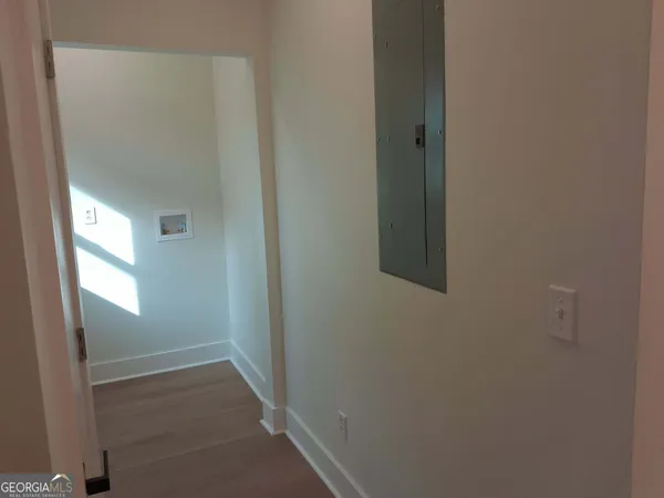a view of a kitchen with a sink and wooden floor