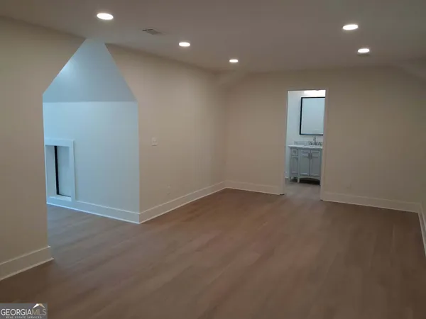an empty room with closet and wooden floor