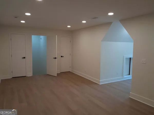 a bathroom with a granite countertop sink toilet and mirror