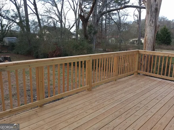 a view of balcony with wooden floor and fence