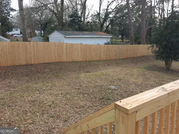 a balcony with view of trees in front of it