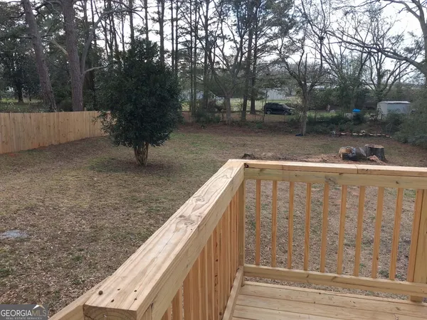 a view of a house with wooden deck
