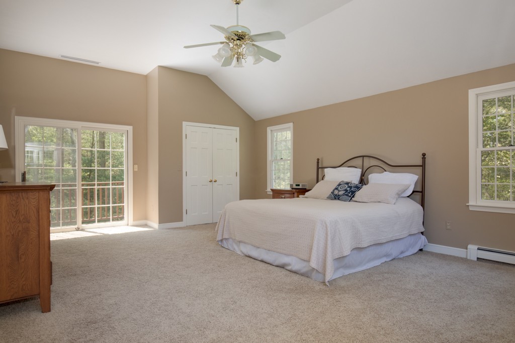6 Leclair Drive Hingham, MA 02043 - Photo 14 of 26 a spacious bedroom with a bed and a chandelier