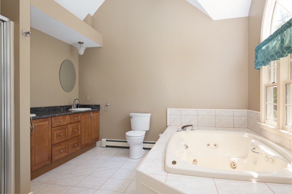 6 Leclair Drive Hingham, MA 02043 - Photo 16 of 26 a bathroom with a granite countertop sink and a bathtub