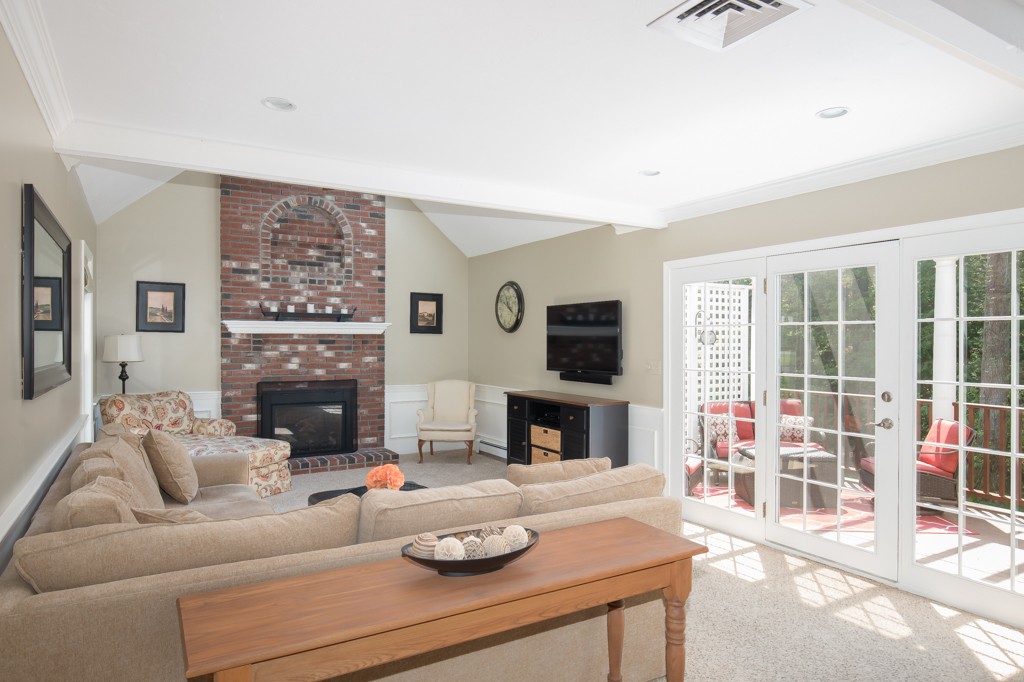 6 Leclair Drive Hingham, MA 02043 - Photo 7 of 26 a living room with furniture a fireplace and a flat screen tv
