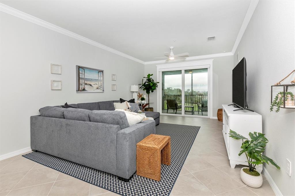 12280 Wellen Golf Street, Unit 403 Venice, FL 34293 - Photo 13 of 97 a living room with furniture large window and flat screen tv