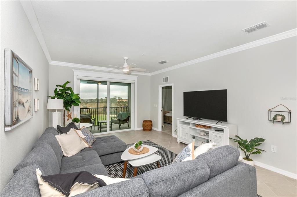 12280 Wellen Golf Street, Unit 403 Venice, FL 34293 - Photo 16 of 97 a living room with furniture and a flat screen tv