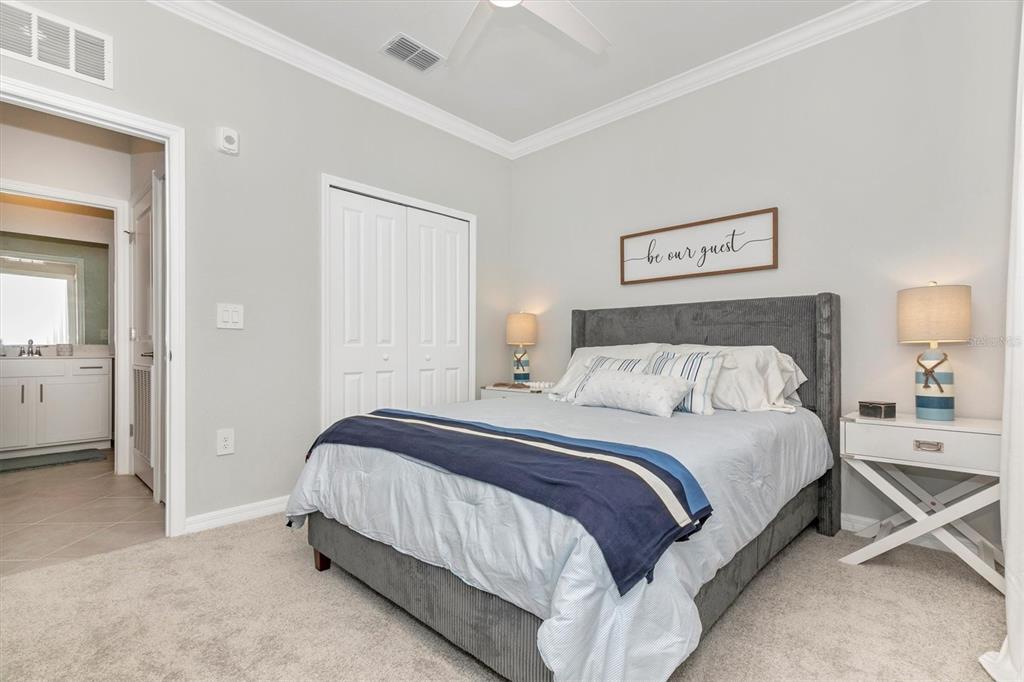 12280 Wellen Golf Street, Unit 403 Venice, FL 34293 - Photo 34 of 97 a bedroom with a bed and a view of bathroom