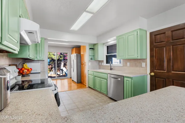 a kitchen with stainless steel appliances granite countertop a refrigerator and a sink