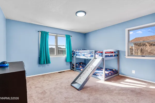 a bathroom with a toilet and a shower curtain