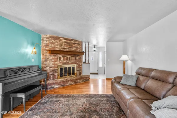 a living room with furniture a fireplace and a flat screen tv