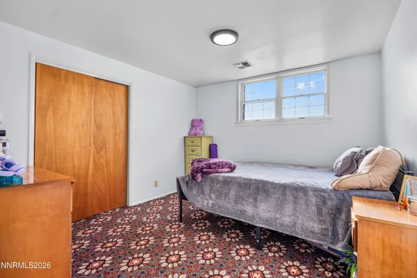 a bedroom with a bed and a cabinets