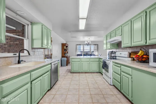 a kitchen with a sink a counter top space and cabinets