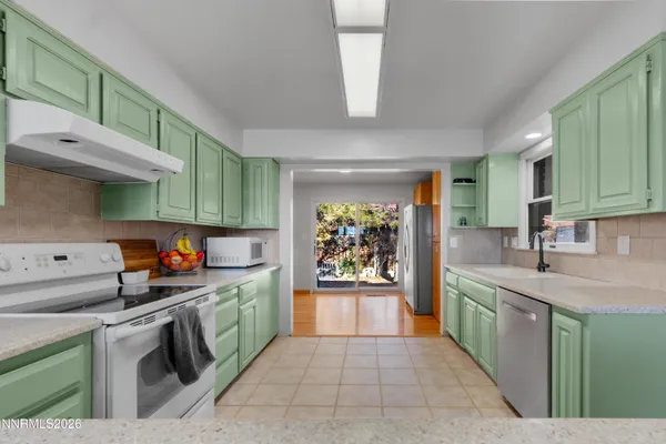 a kitchen with stainless steel appliances granite countertop a sink and cabinets